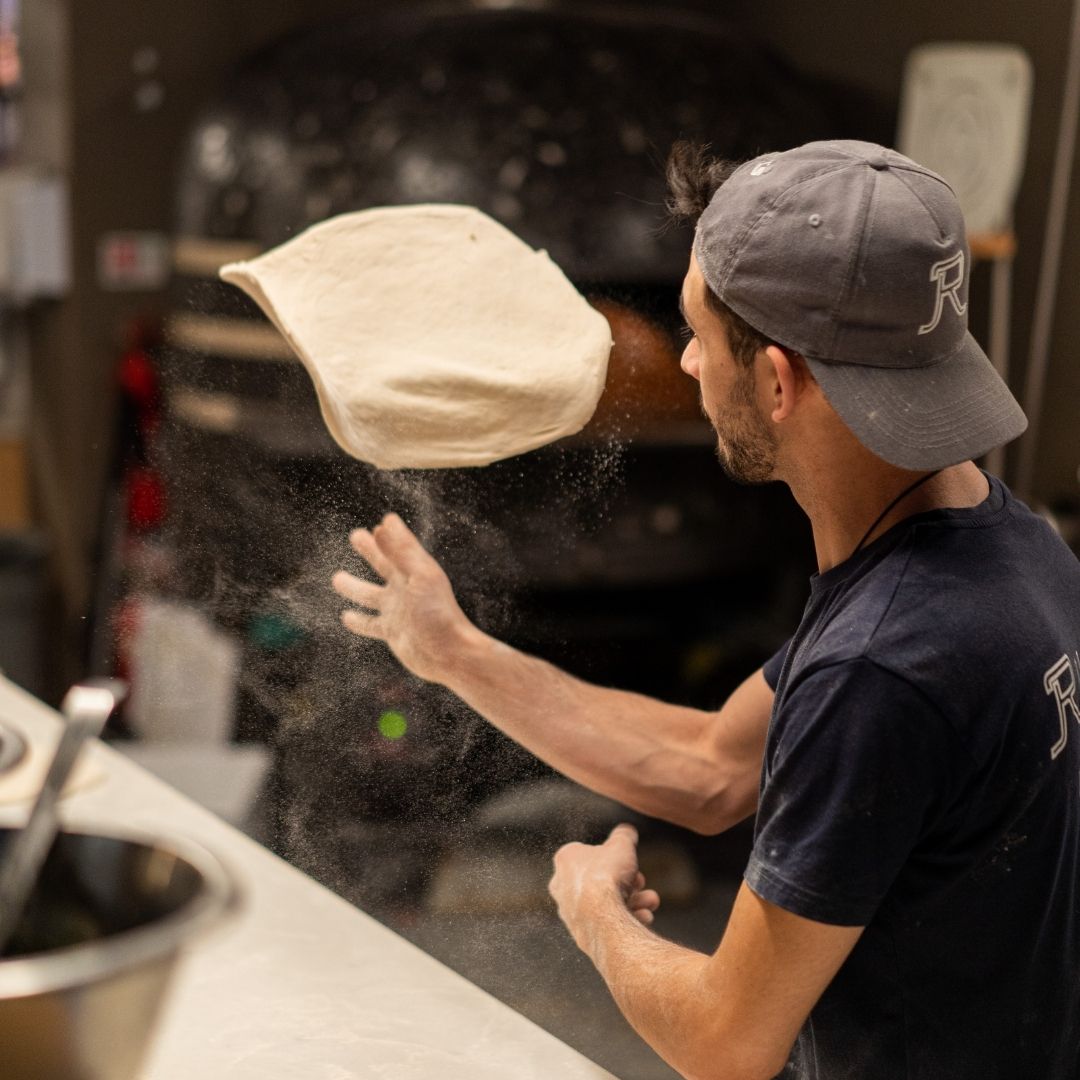 picture of pizzaiolo tossing dough