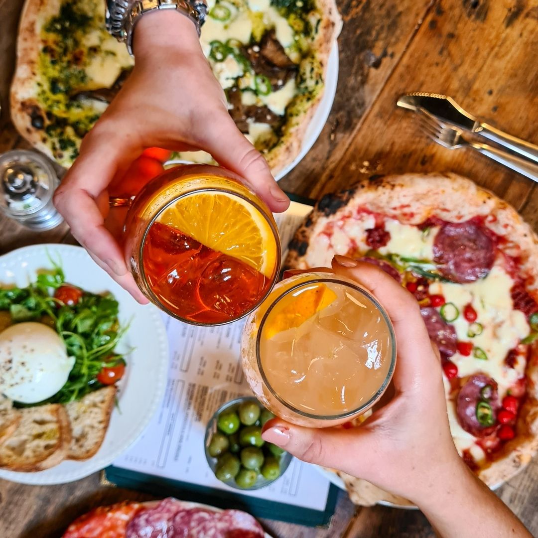 picture of cocktails clinking