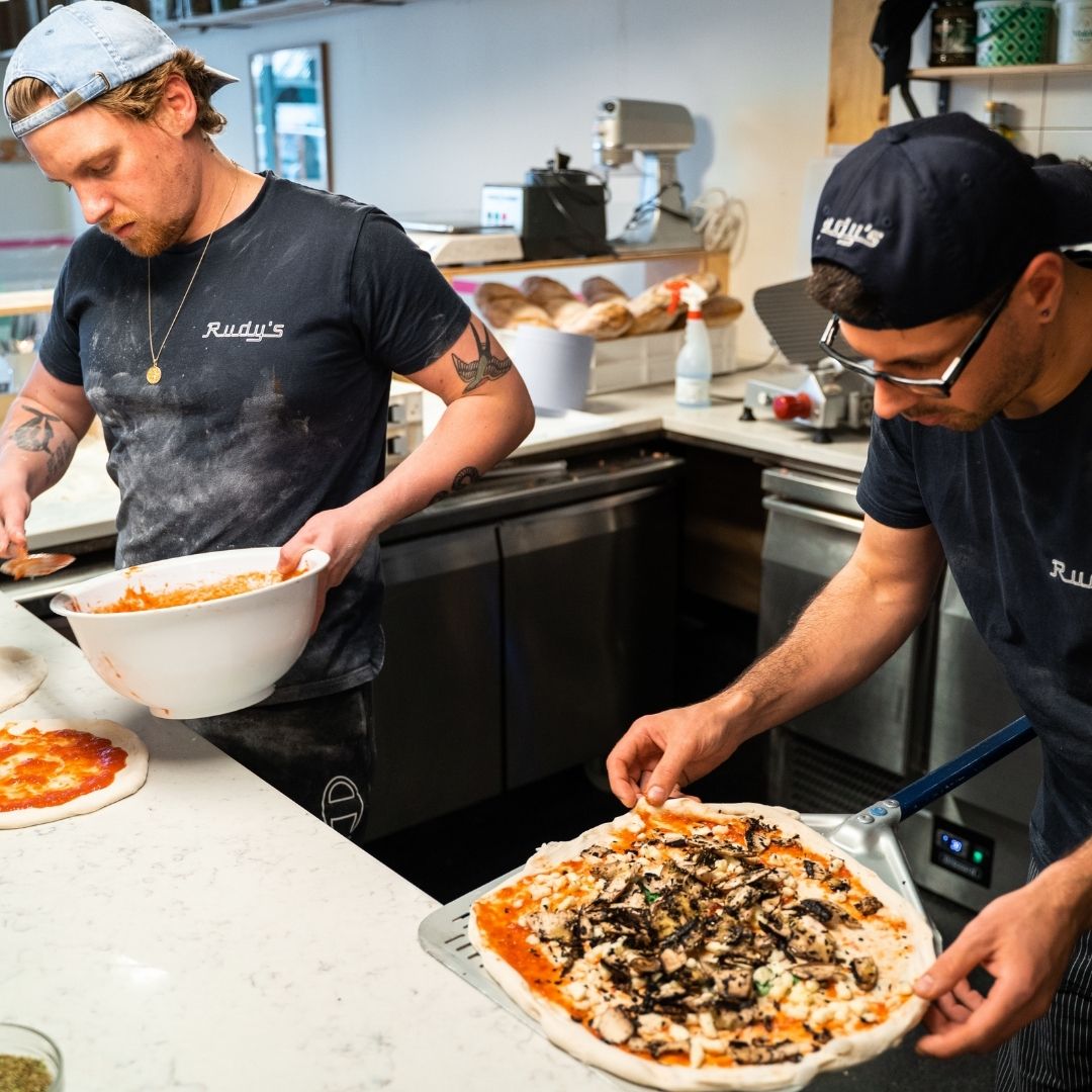 rudy's pizzaiolo making a pizza
