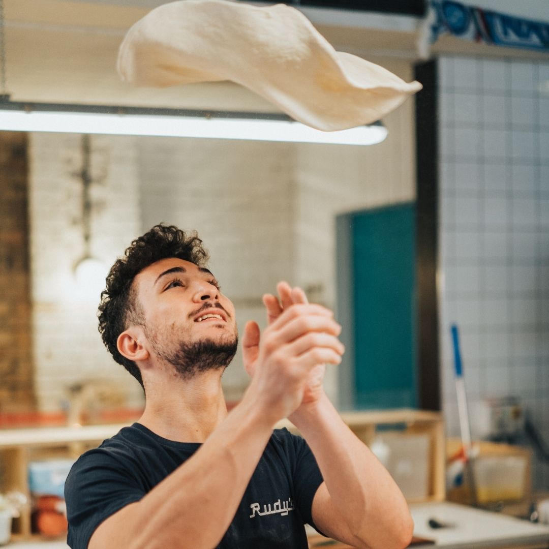 picture of pizzaiolo chucking dough