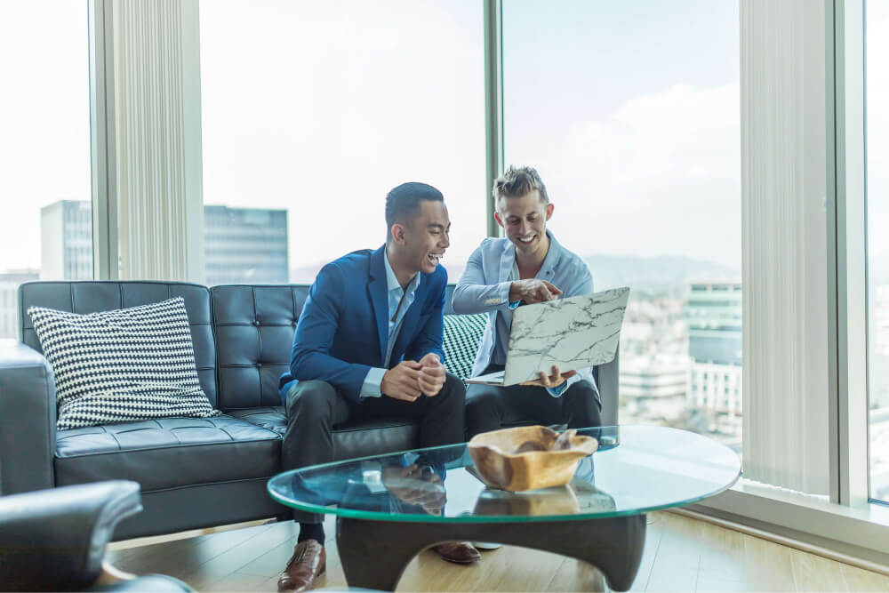 Two men looking at laptop