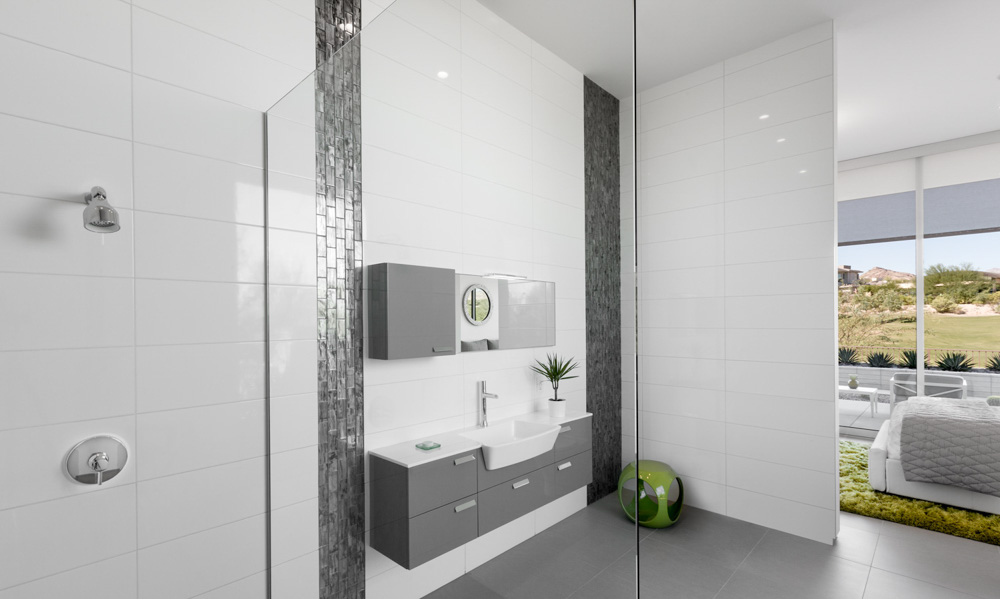 A modern minimalist residential master bathroom with neutral colors professionally styled with the master bedroom in the background all captured during the day with natural light.