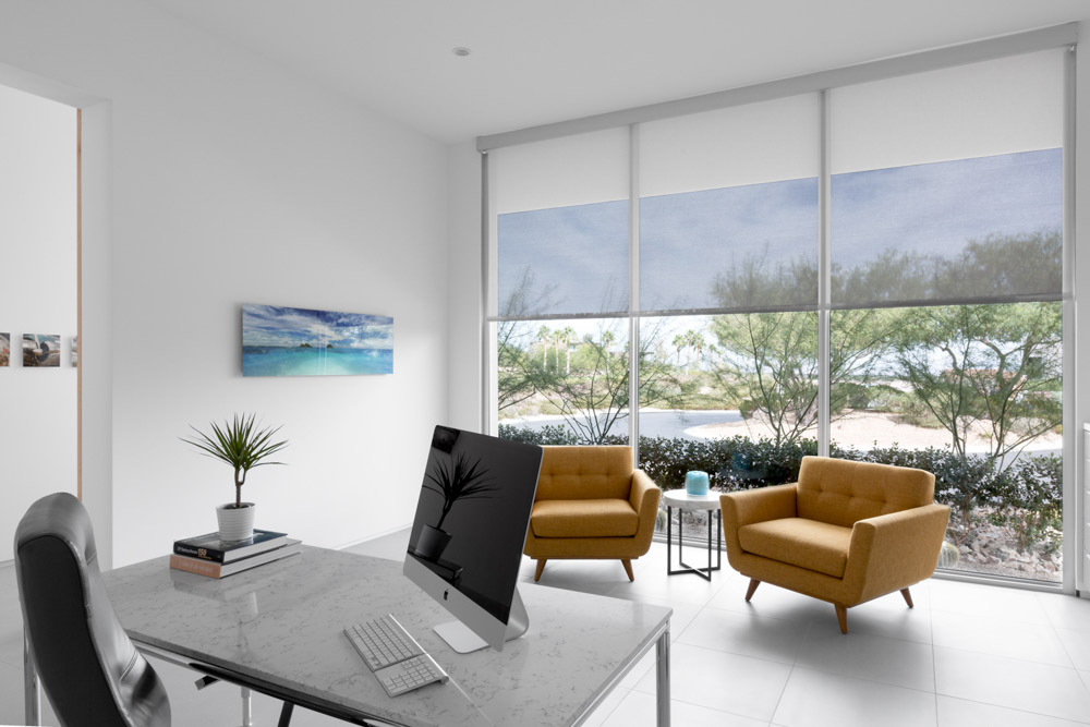 A modern minimalist residential office with neutral colors professionally styled with big windows all captured during the day with natural light.