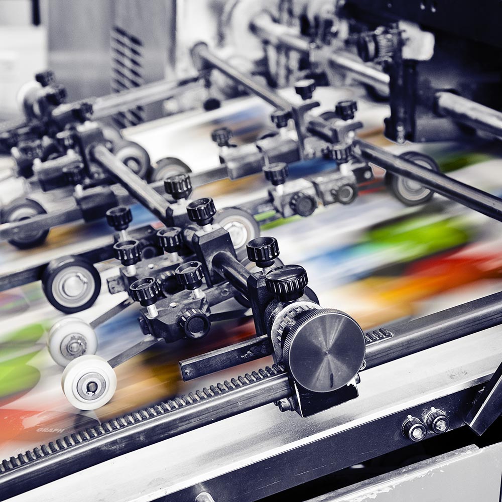 Printing press printing designs on custom film.