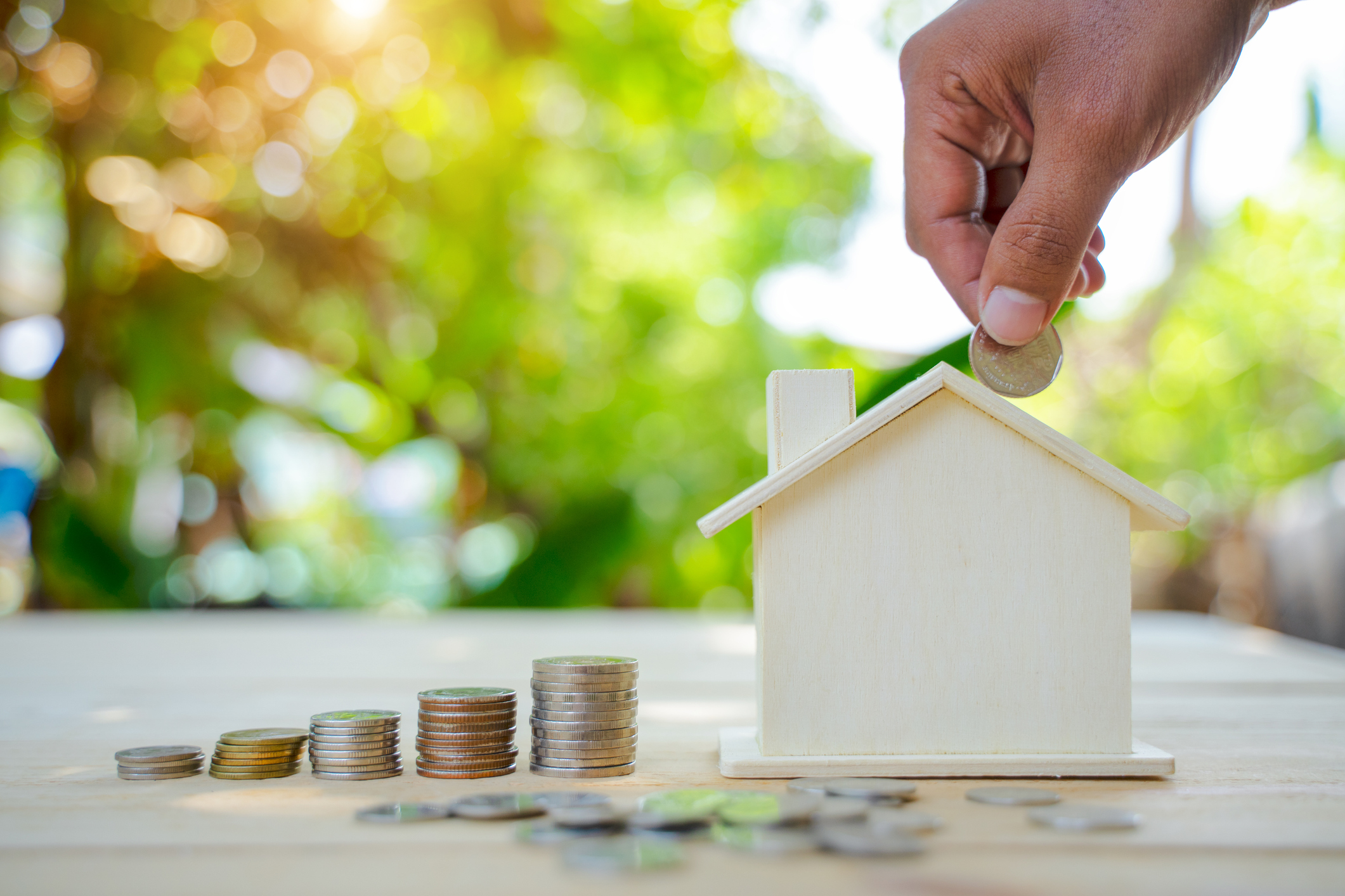 stock image of a house and money being invested