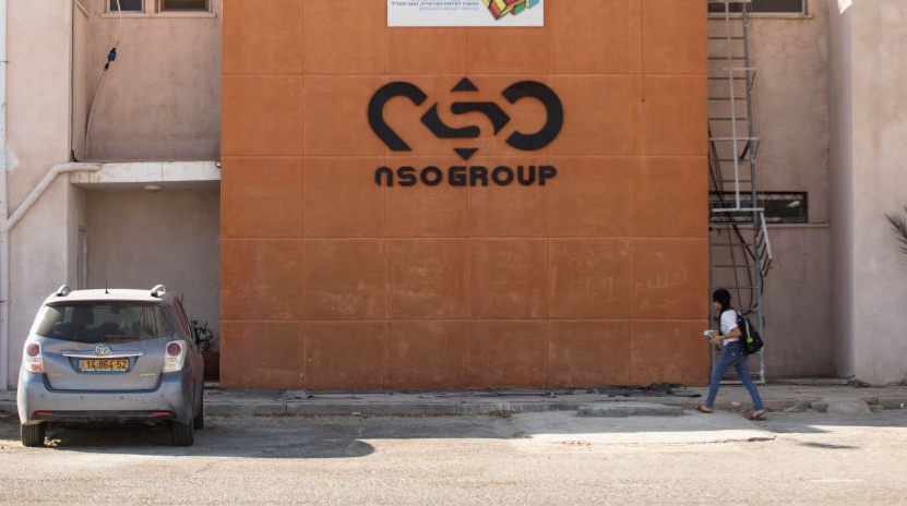 A woman walks by the building entrance of Israeli cyber company NSO Group