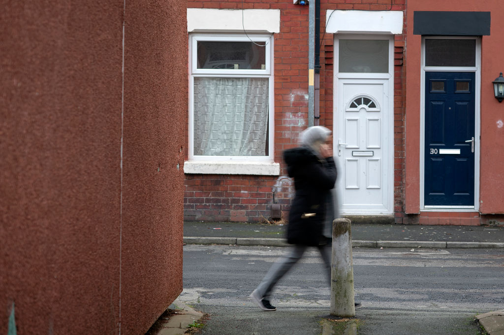 A youth walks through the Gorton area of Manchester on December 04, 2018
