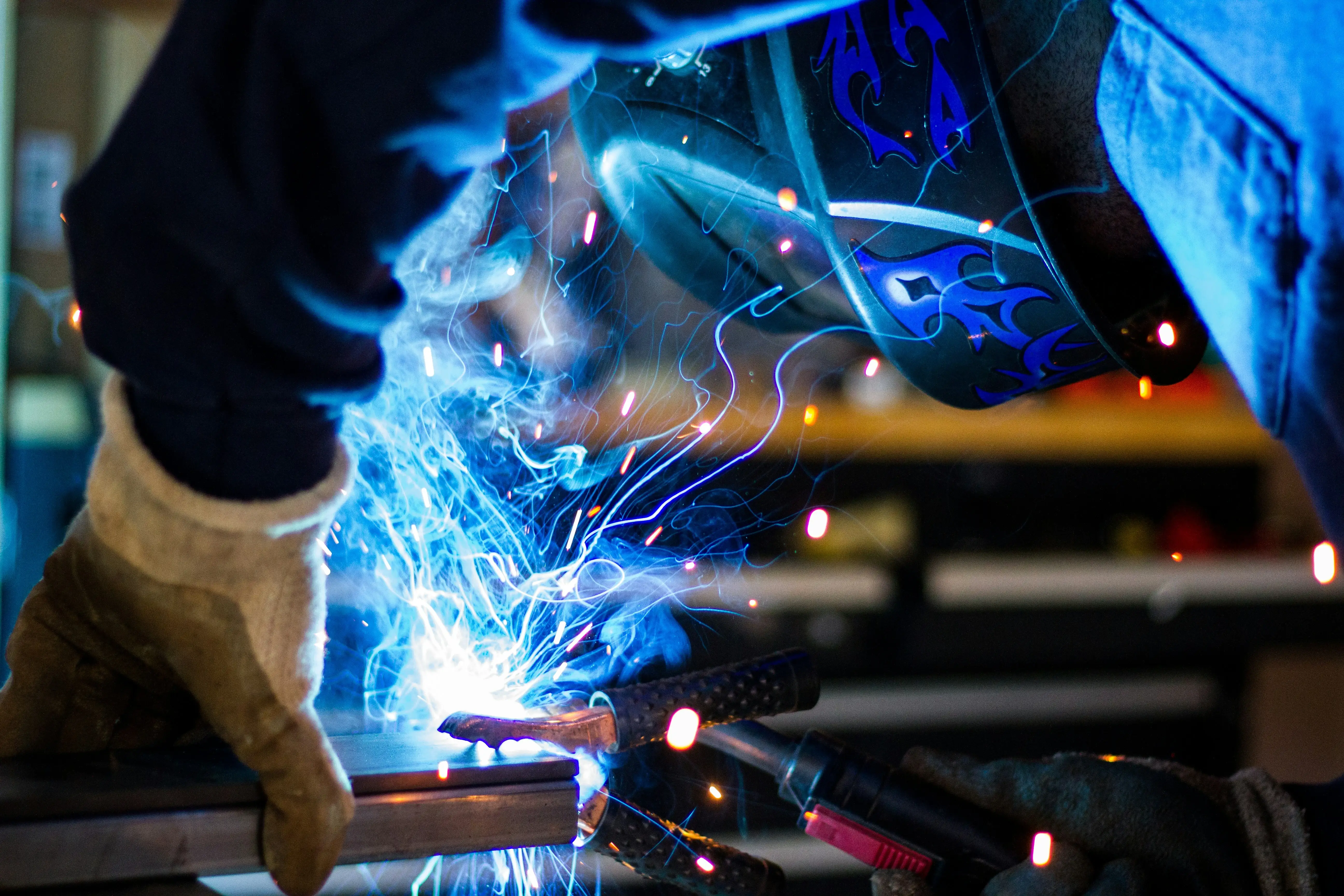 person welding with sparks flying