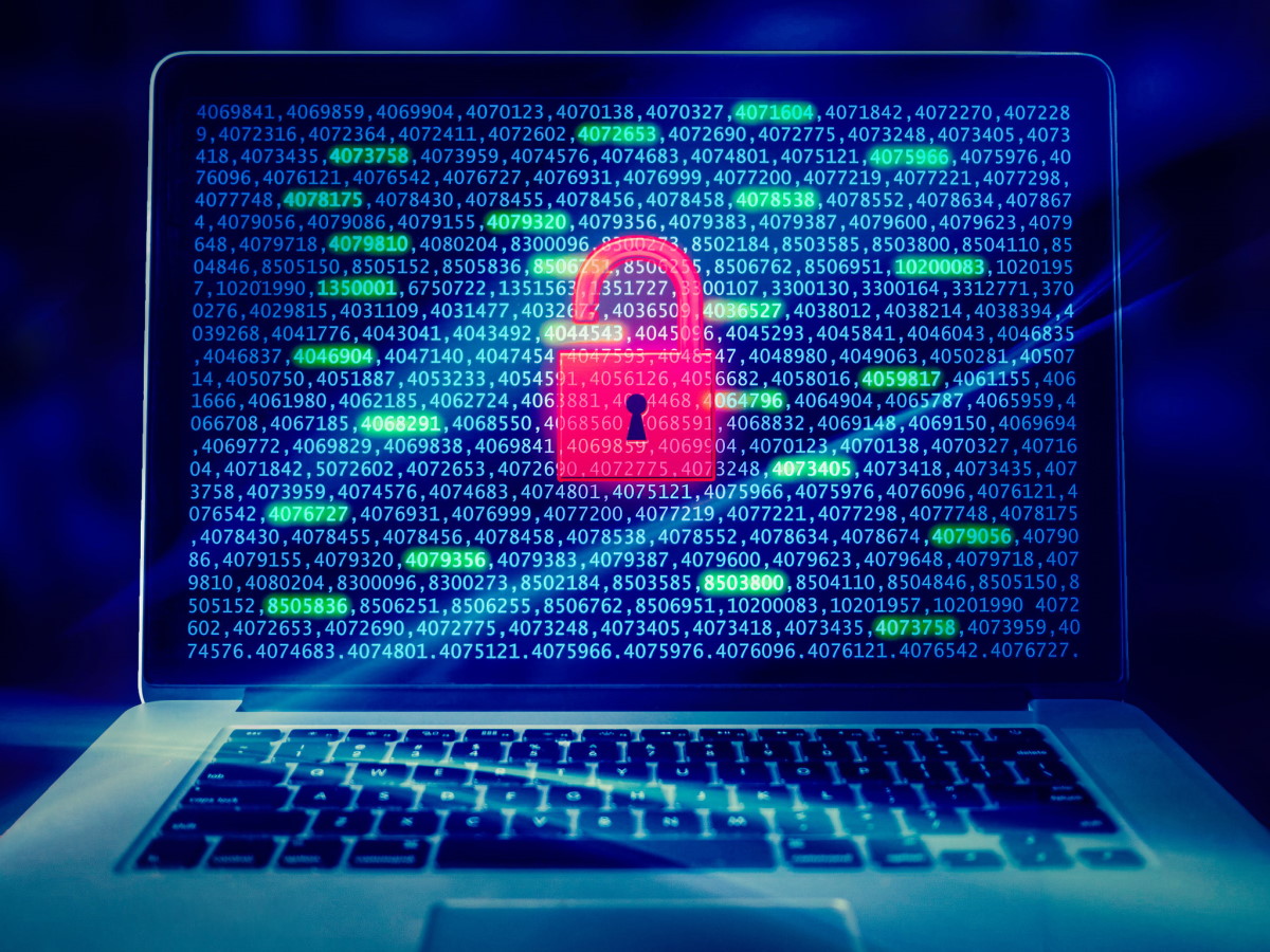 Picture of a computer screen and keyboard with data strings on the screen. A pink padlock is superimposed onto the computer screen.