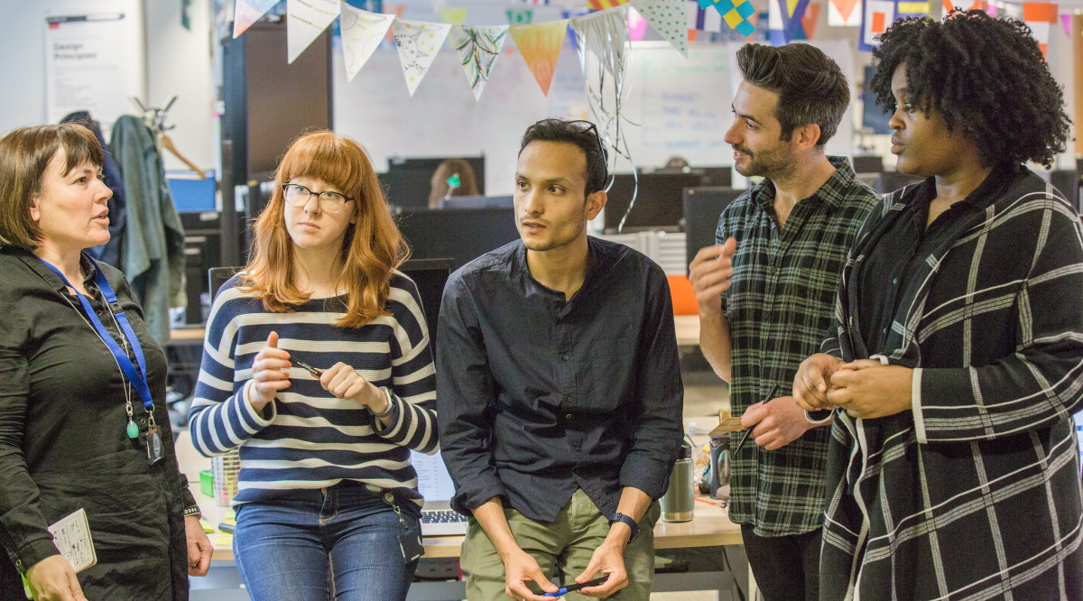 Picture of five people in an office setting