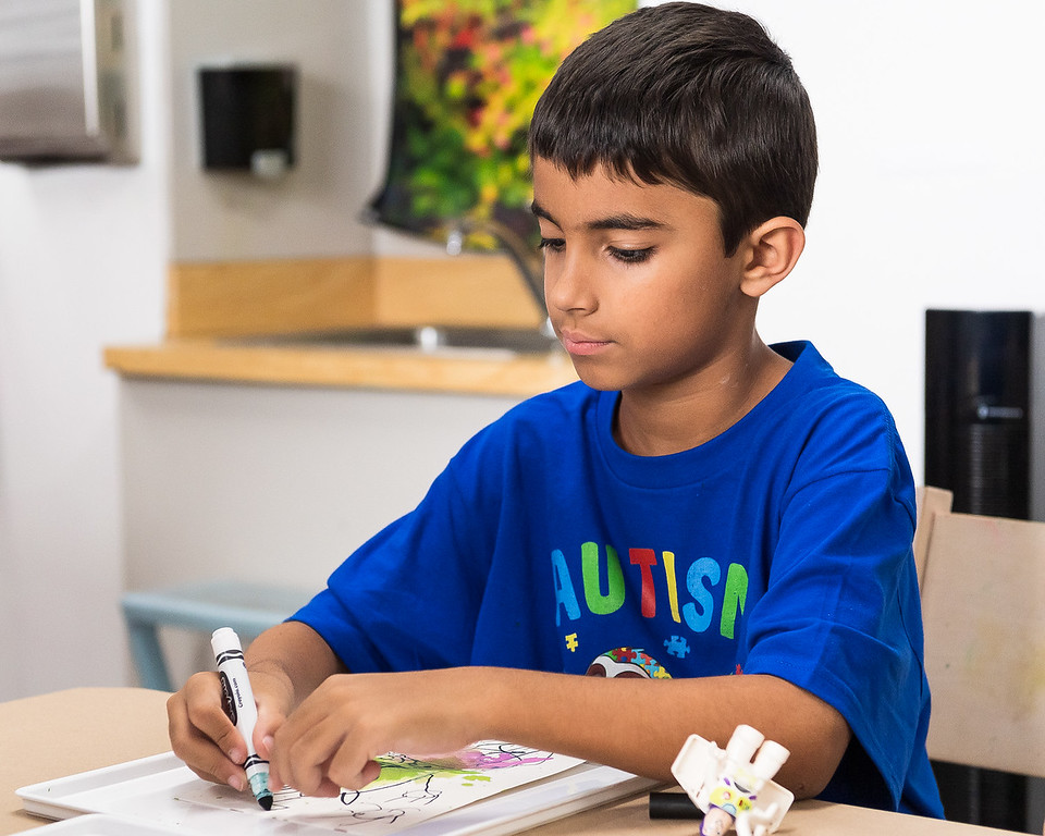 A little boy stands playing with magnatiles in the All About Art Gallery
