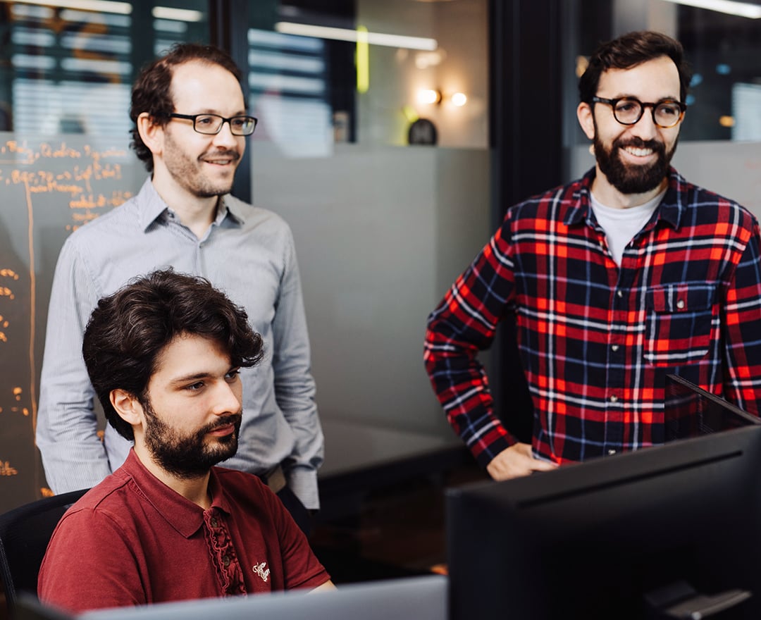 Colleagues looking at screen in office