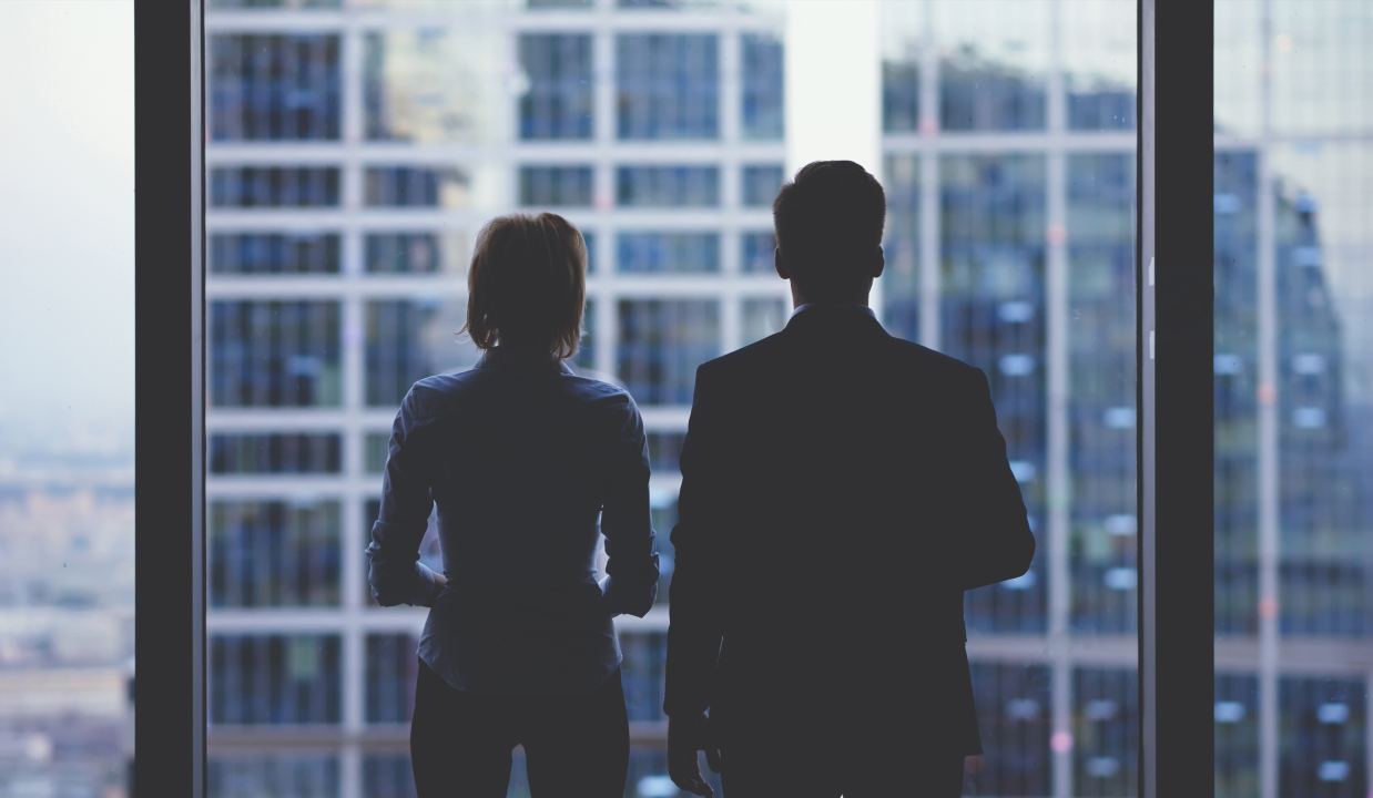 business team members looking out of office window