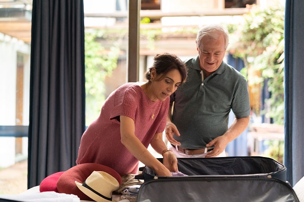 Couple Packing Suitcase