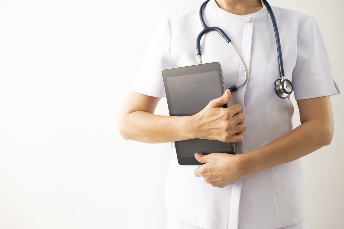 Nurse is holding a tablet