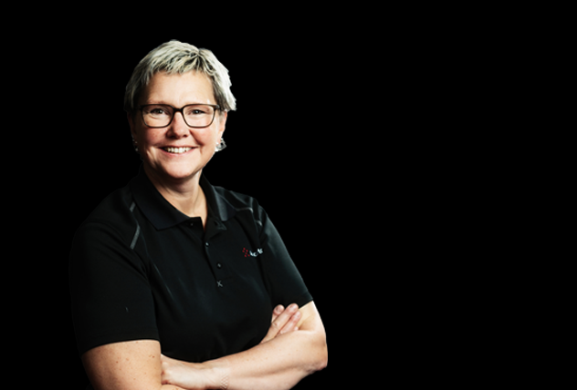 A red AutoStore R5 warehouse robot located on top of an AutoStore Grid.