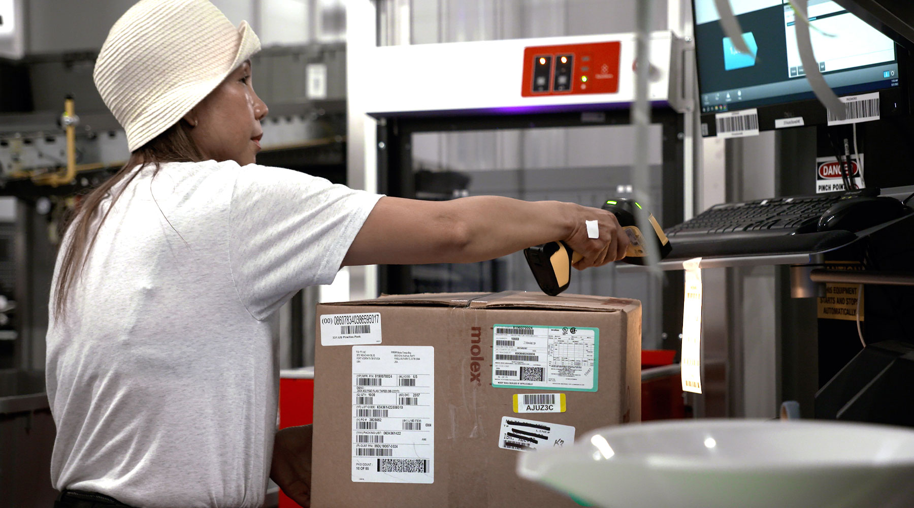 A TTI employee picking goods at an AutoStore workstation
