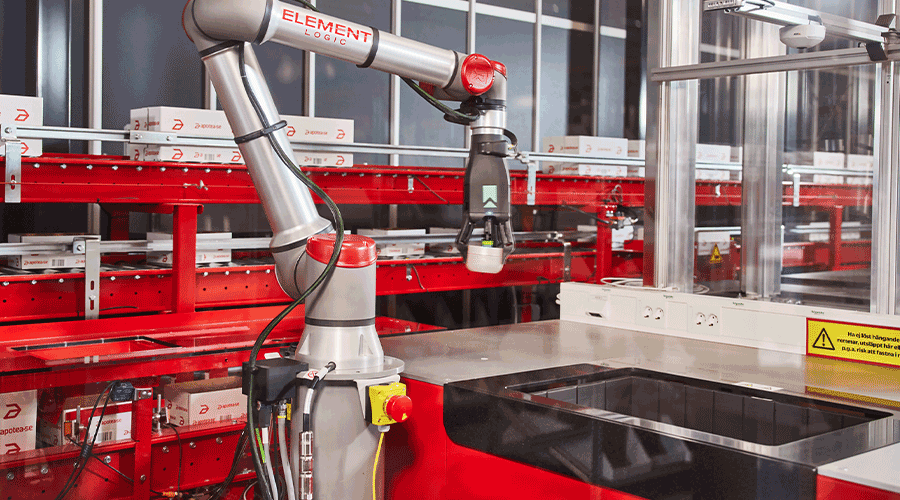 Robotic arm picking items from AutoStore and placing on conveyor. Image.