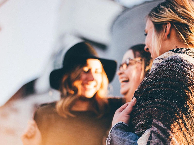 Three female friends chatting and laughing