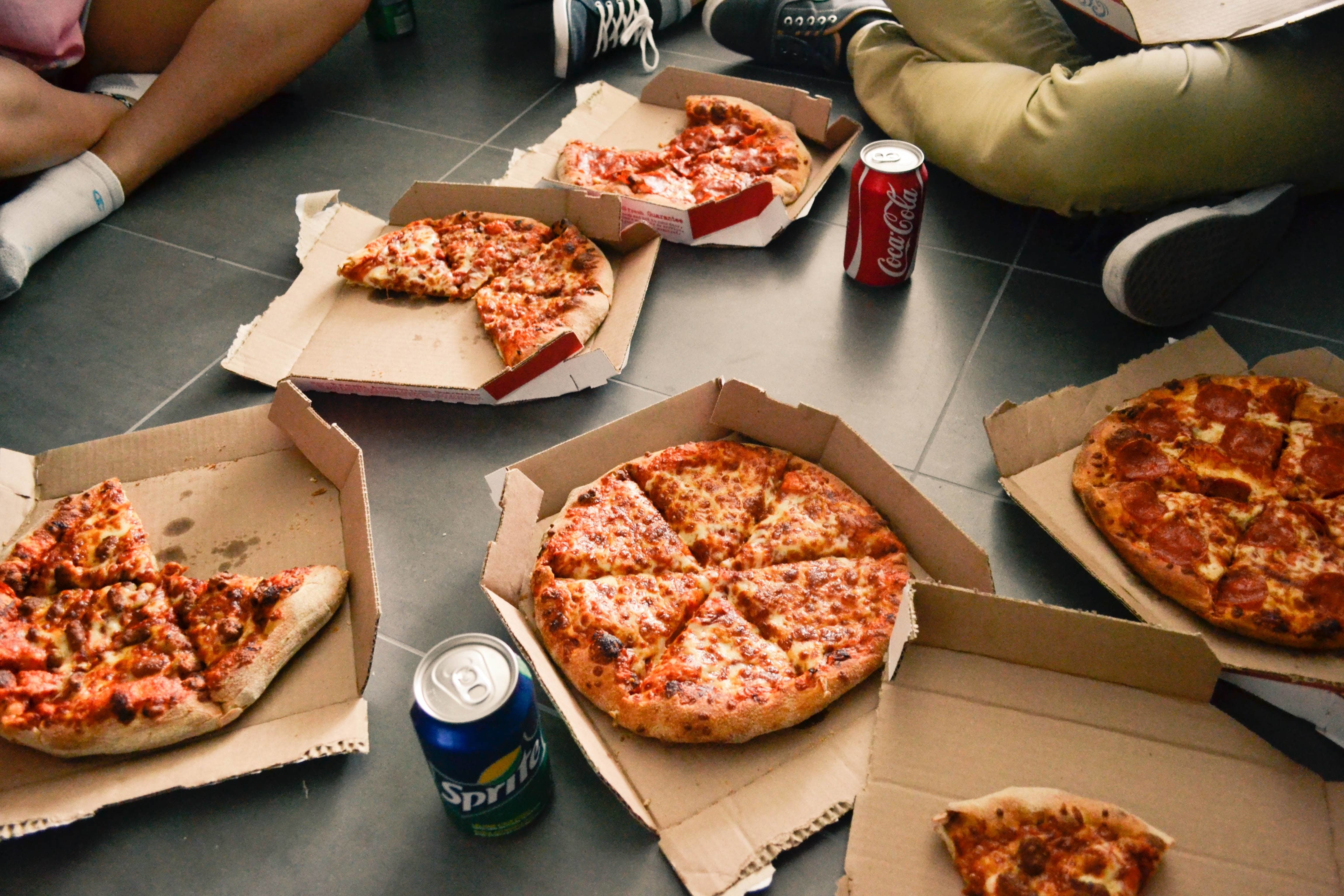 Spread of pizza and soft drinks.