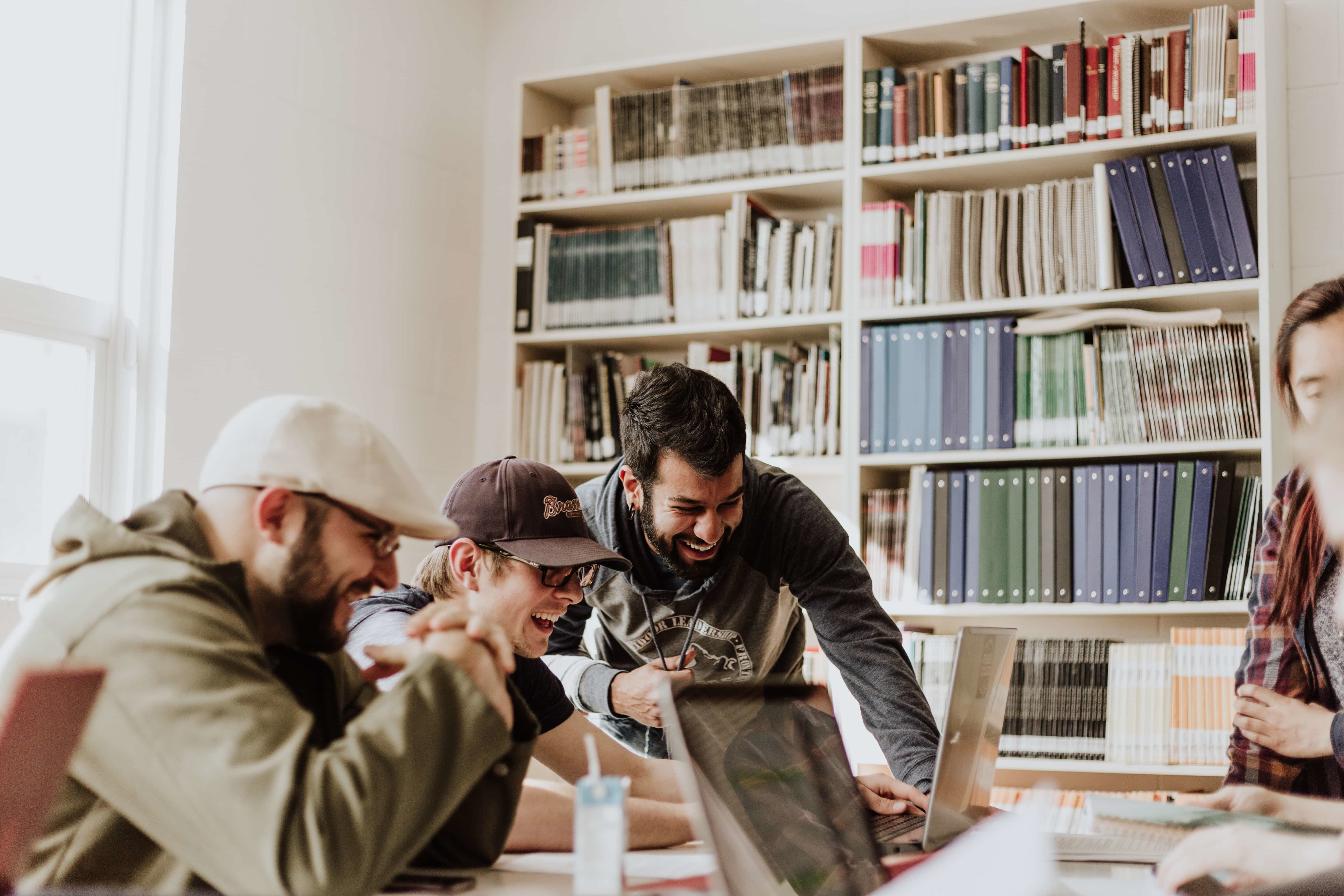 A group of startup employees laughing together