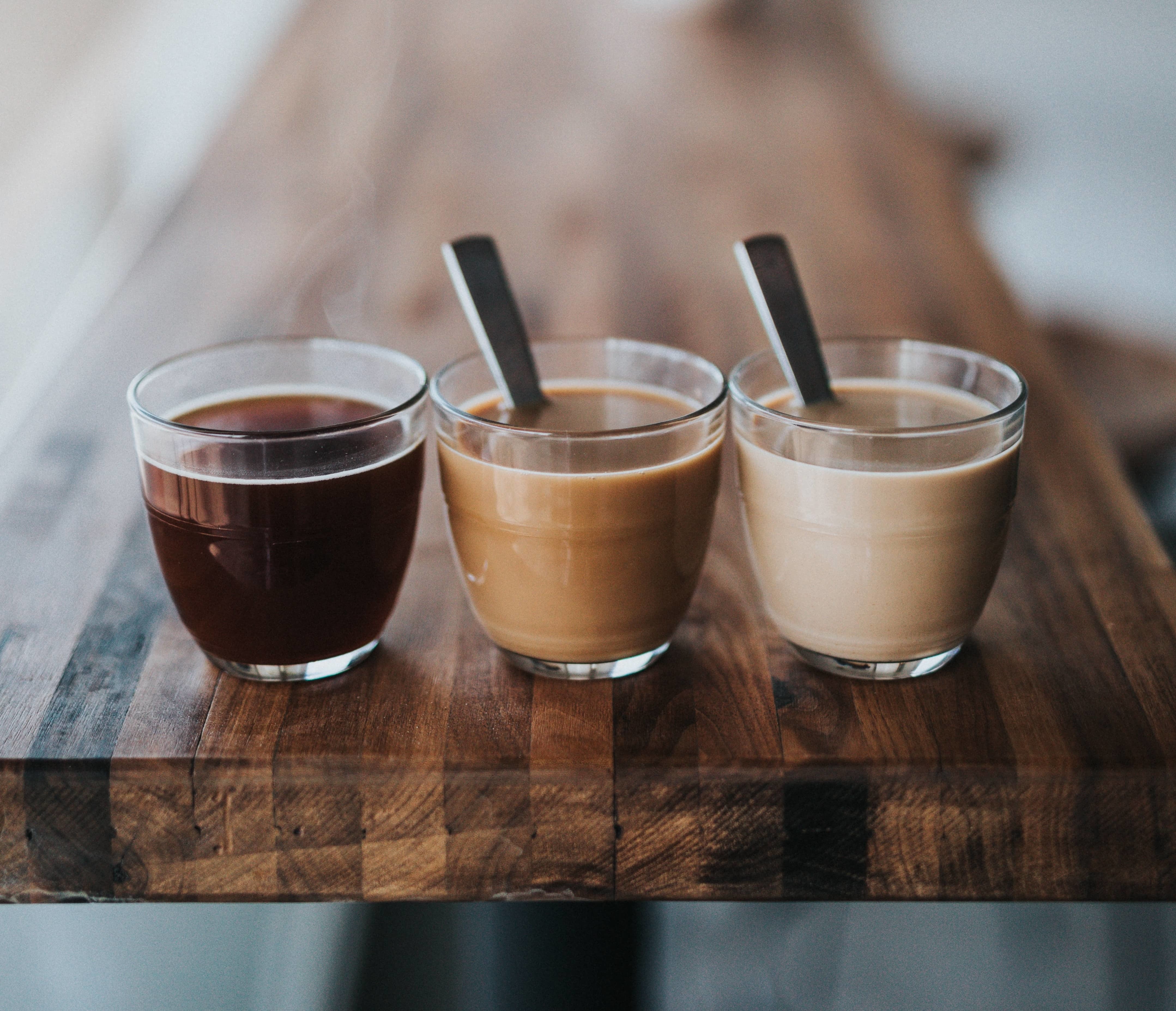 Three coffees on a tabletop.