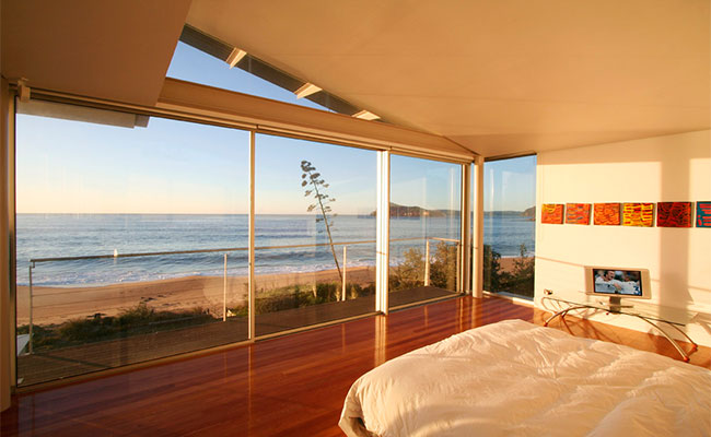 Double glazed window wall in master bedroom with ocean views.