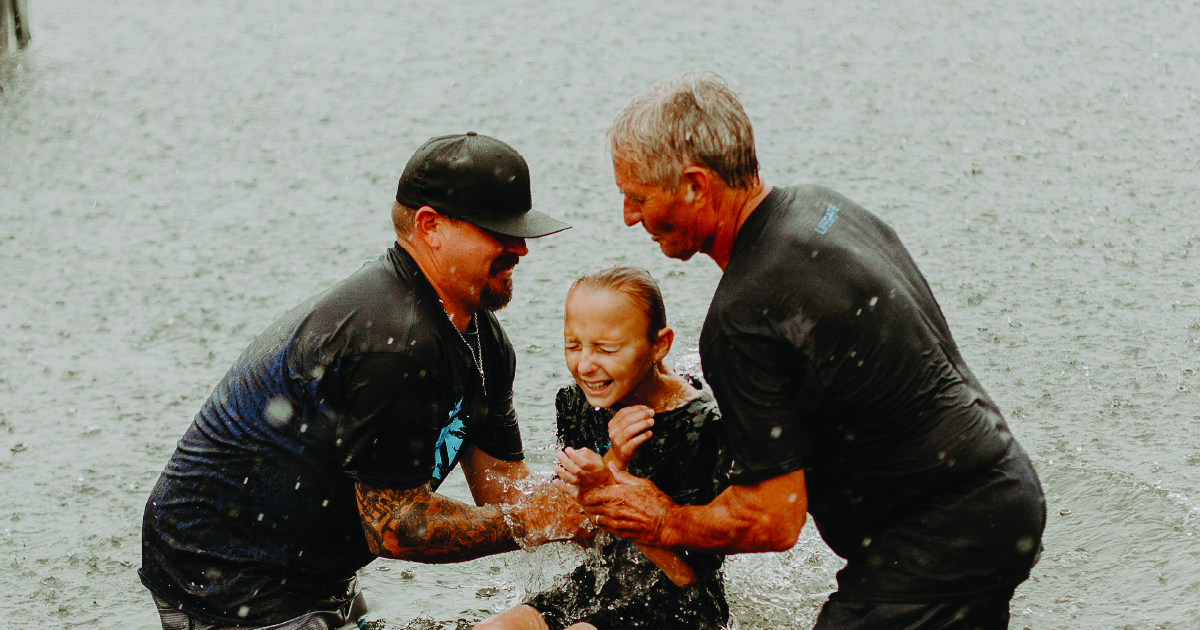 Baptizing a person in a lake at Lifegate Church