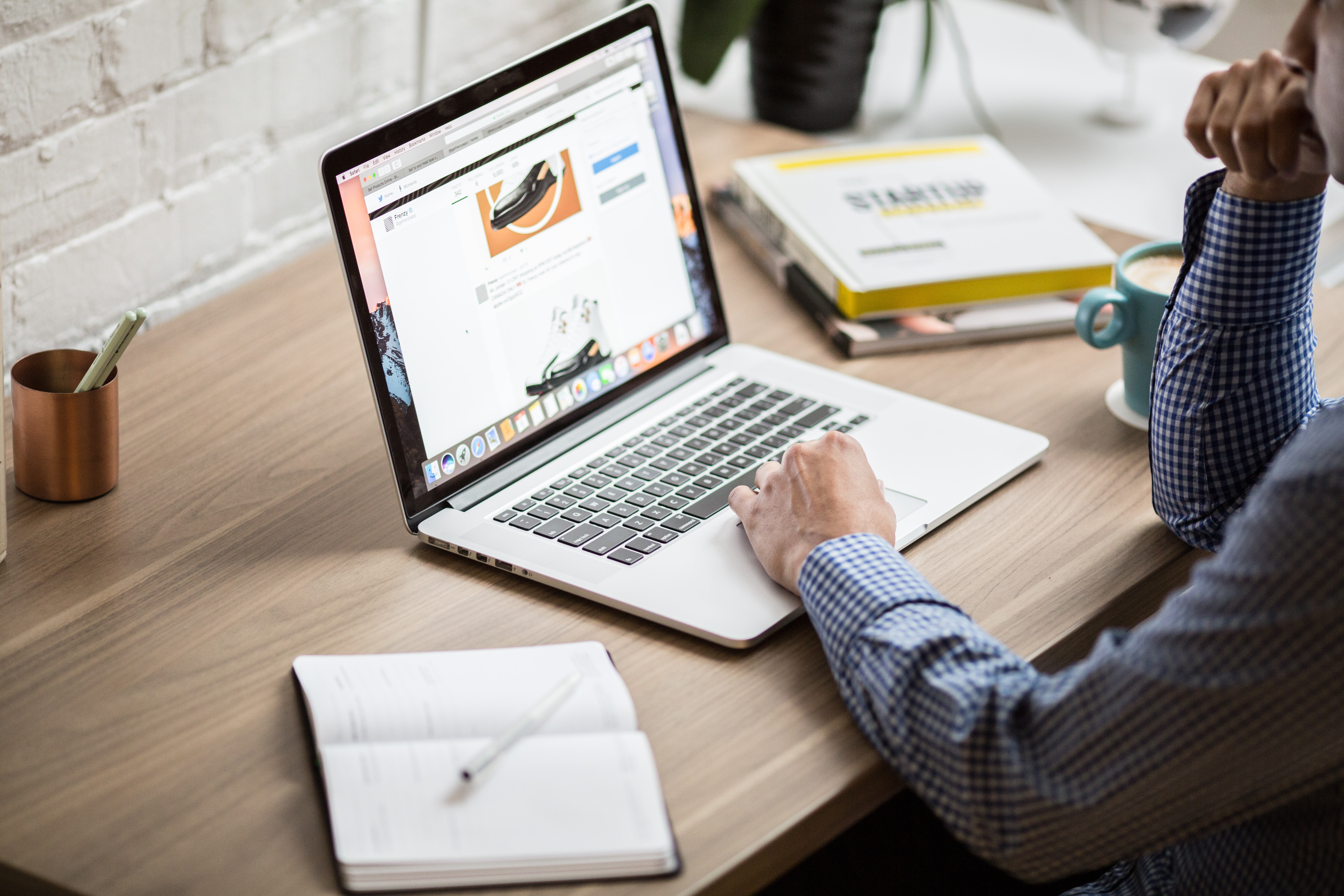 A person using a laptop on a table