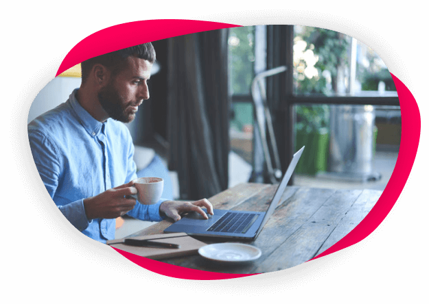 Image of a man working at a laptop