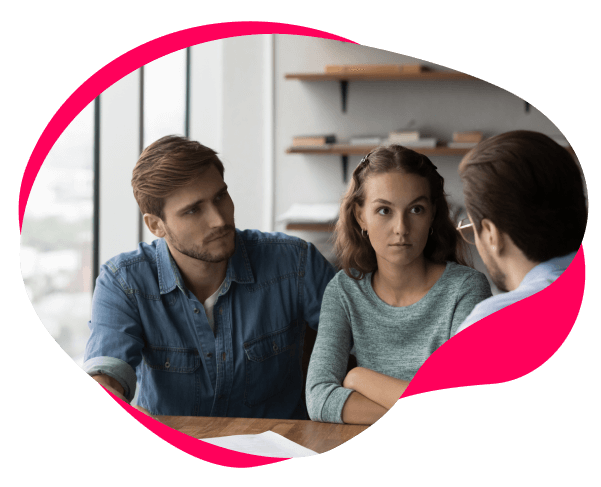 Image if a couple looking dissatisfied speaking to a bank manager