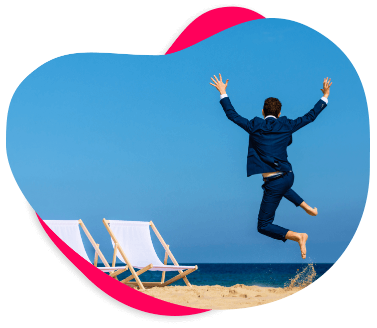 Image of a man in a suit jumping for joy on a beach