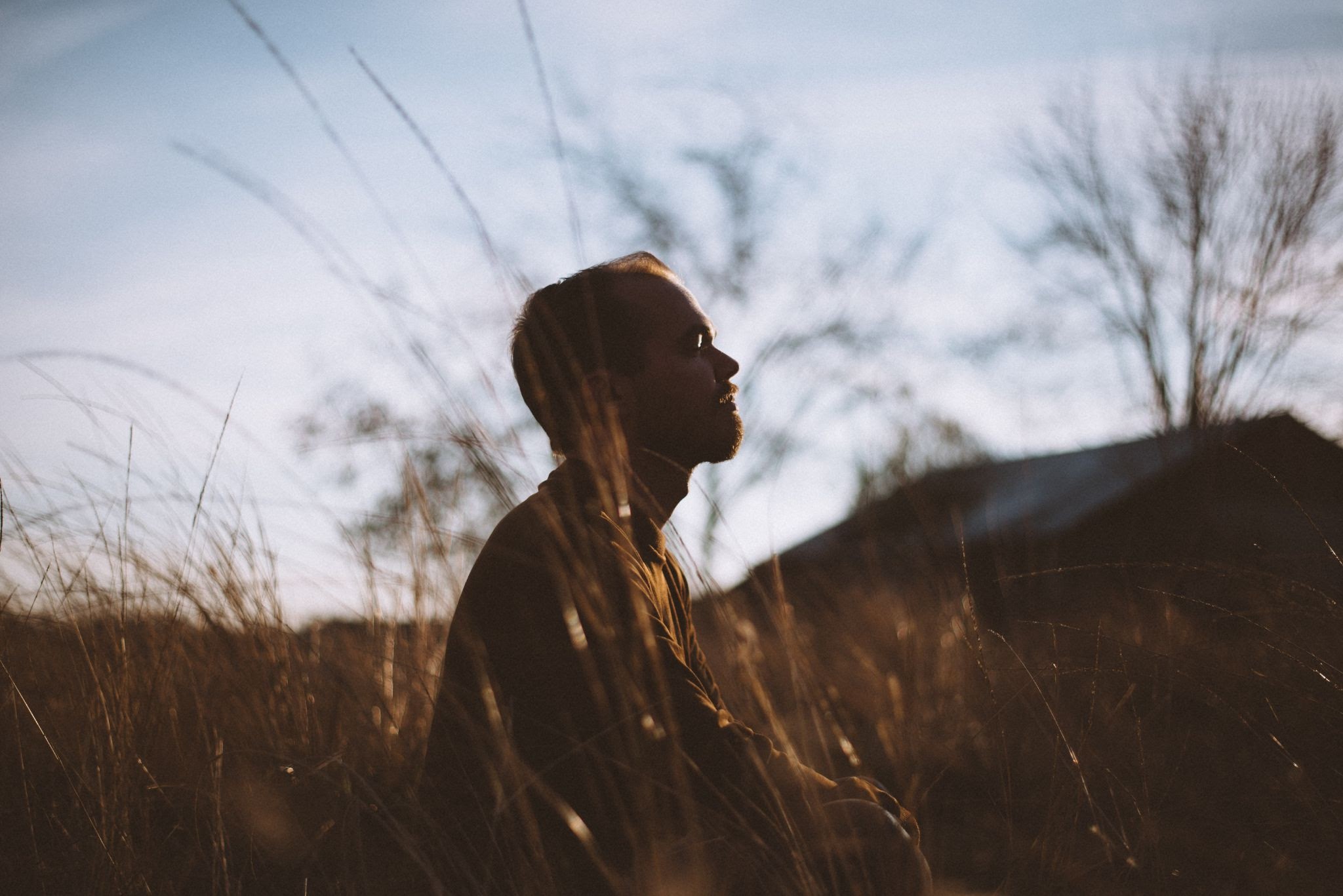 man meditating in a field