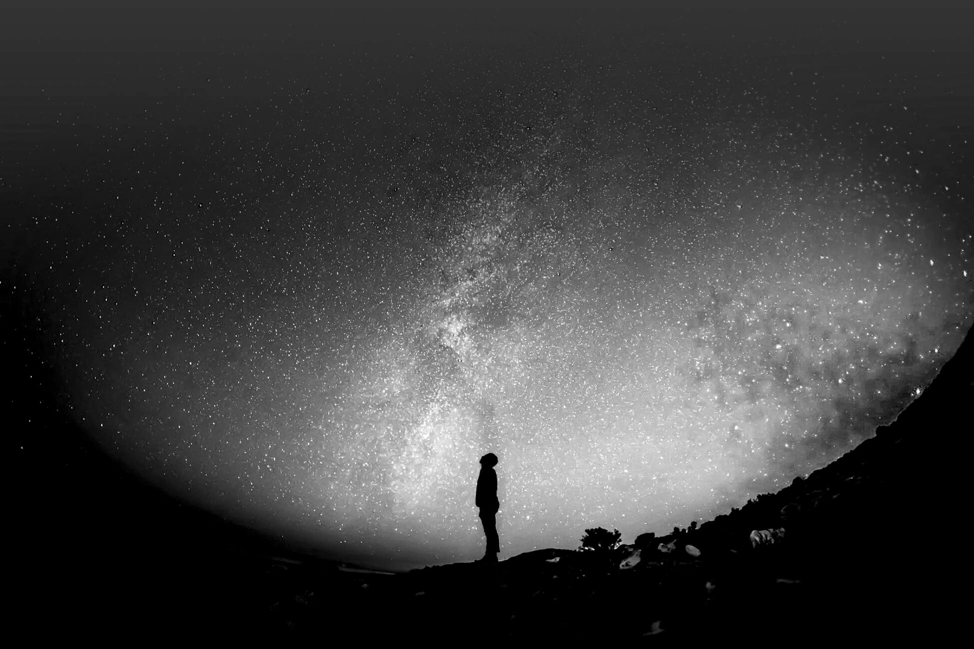 Person standing underneath the moon