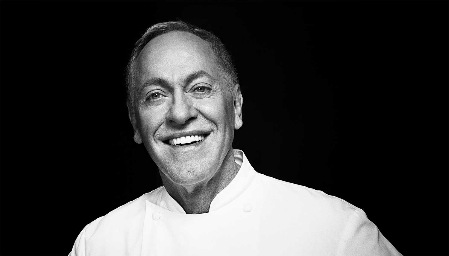 A black and white headshot of Chef Patrick O'Connell, smiling.