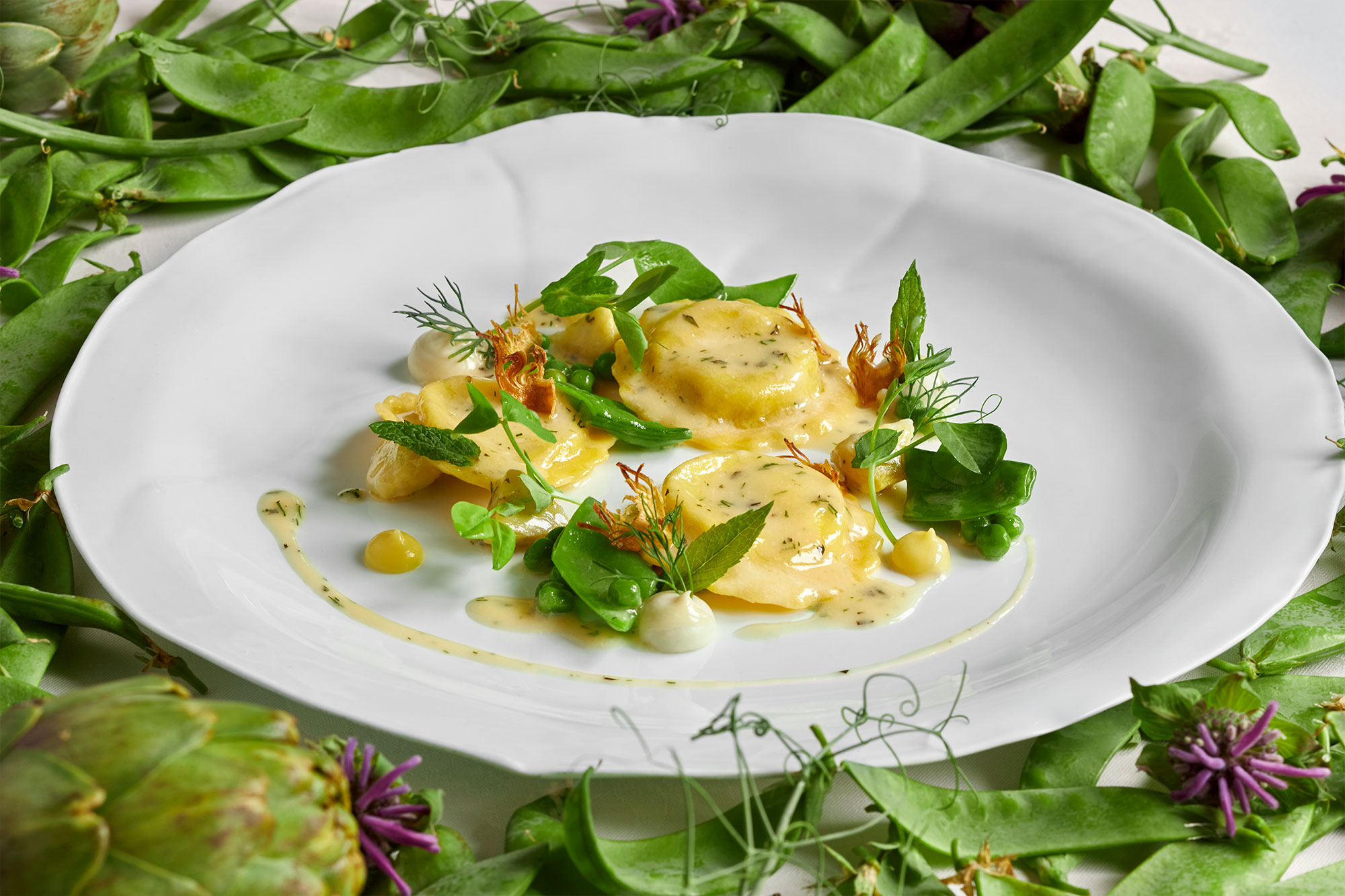 Potato-Leek and Mascarpone Ravioli with Spring Peas, Artichokes and Lemon Essence