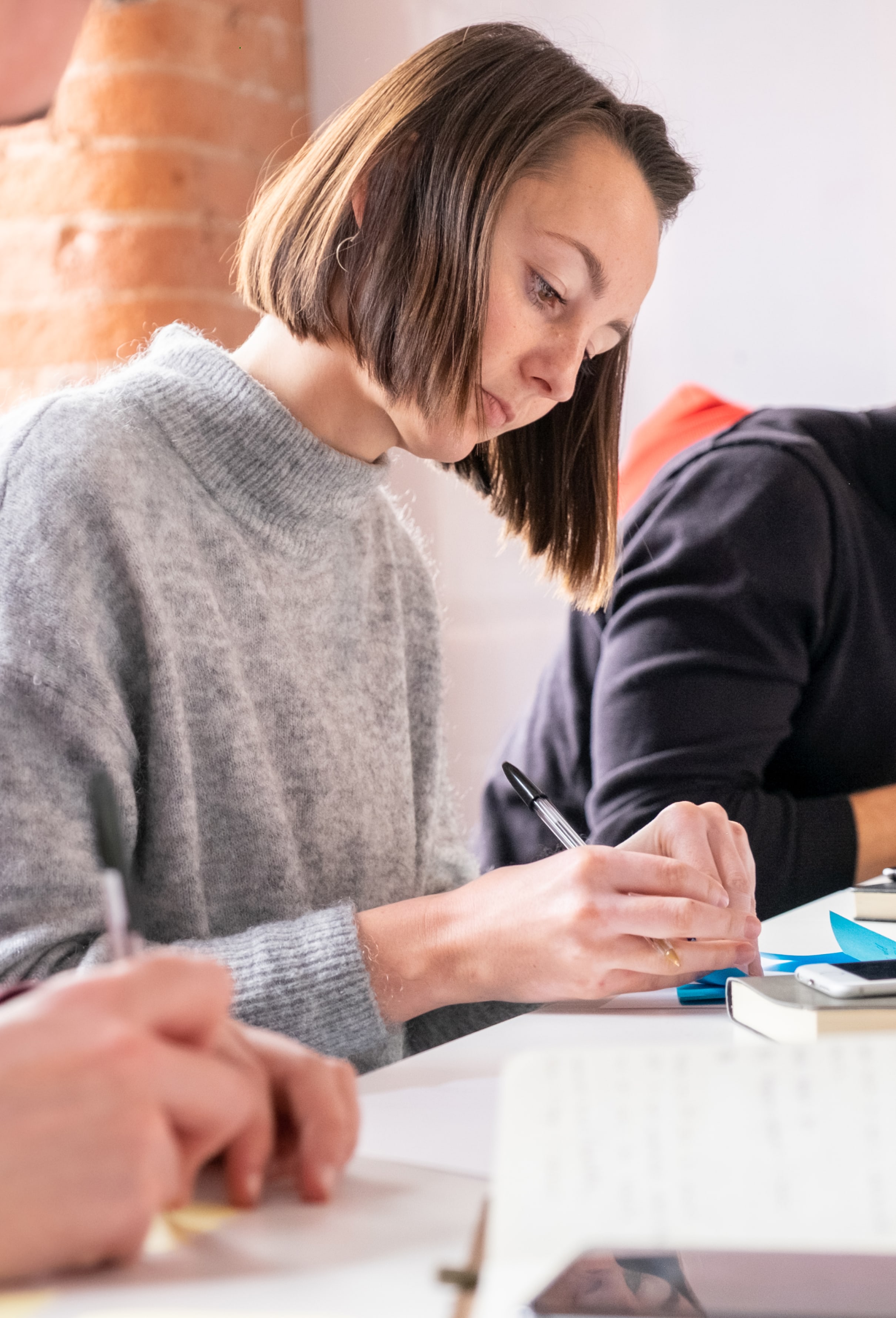 A photo of one of our team taking notes.