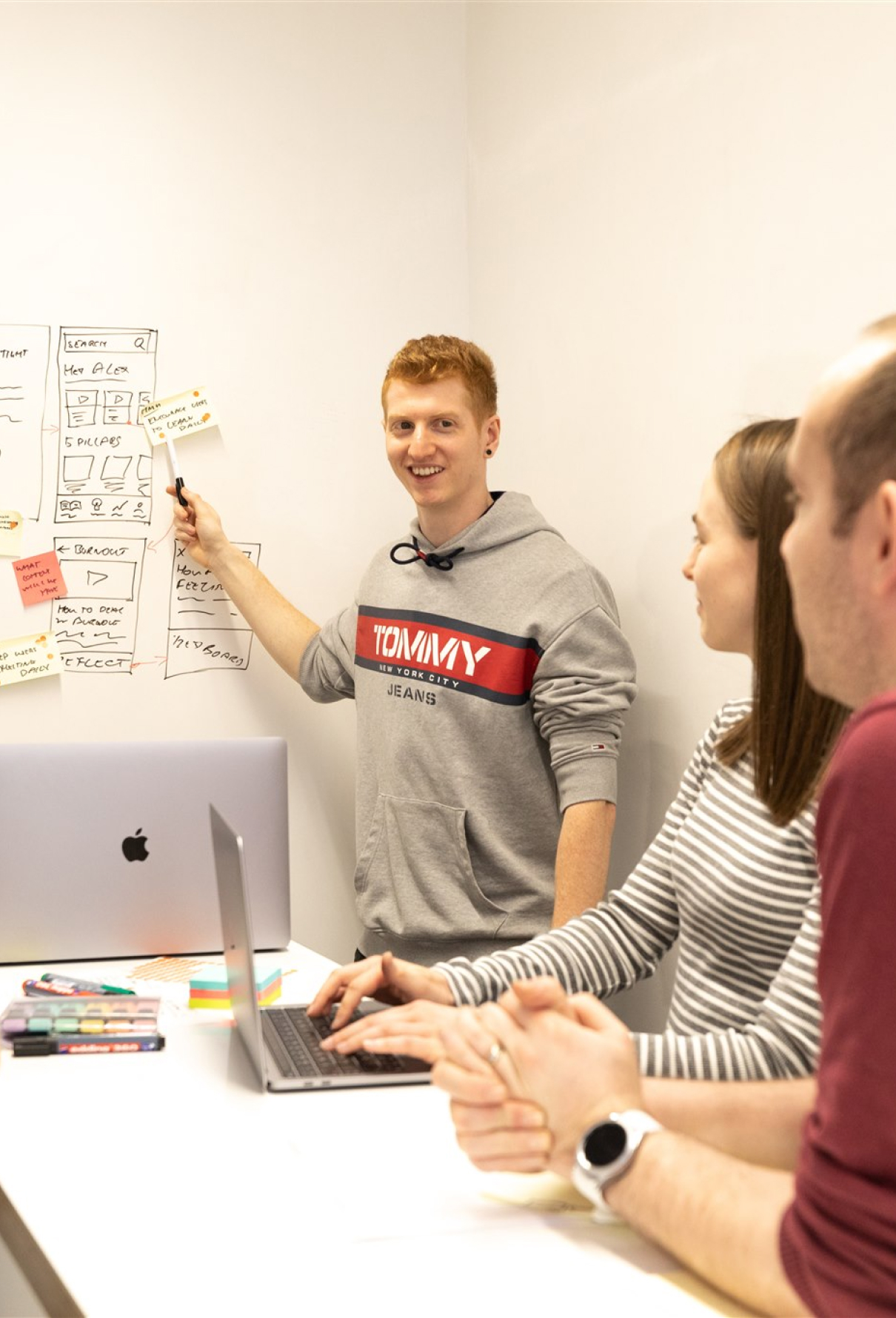 A photo of one of our designers, Curt, going over some prototype sketches with the rest of the team.