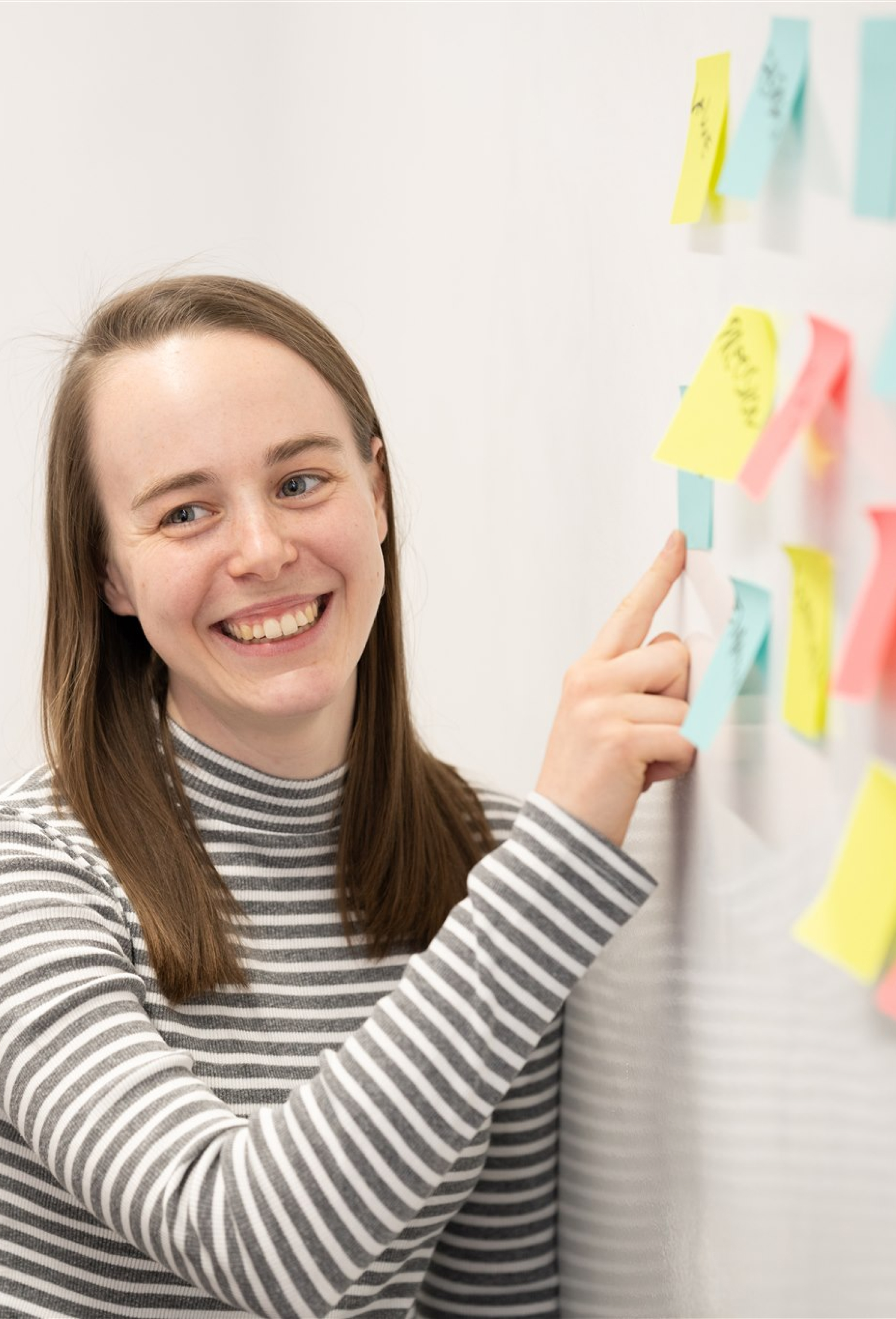 A photo of Madeleine smiling while going through some notes.