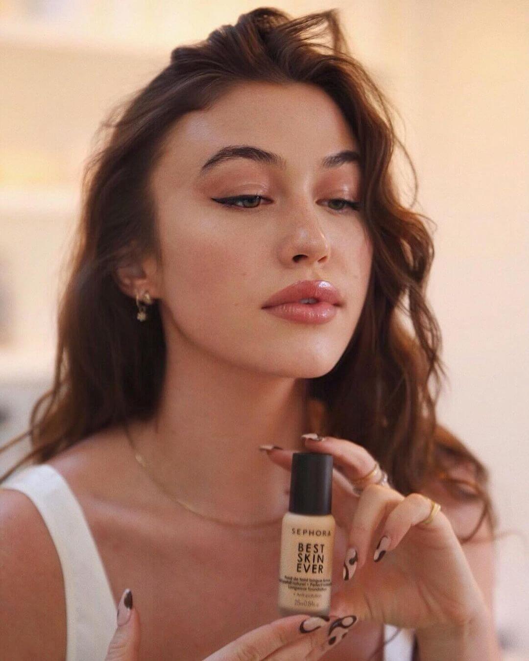 Woman with foundation bottle