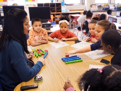 Kids in classroom are learning math from their teacher