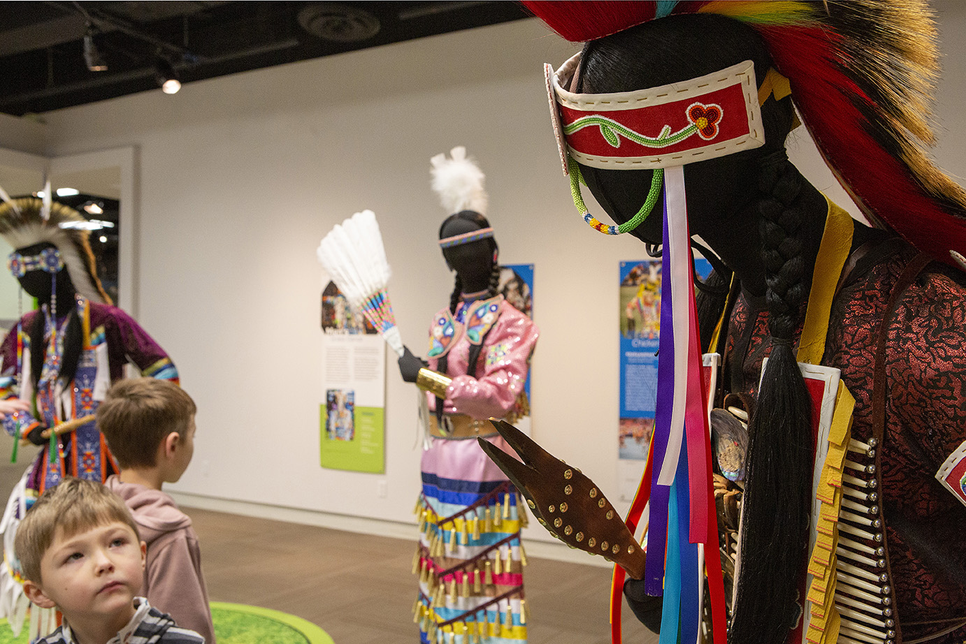 Red Deer Museum & Art Gallery with children admiring the aboriginal regailia displays