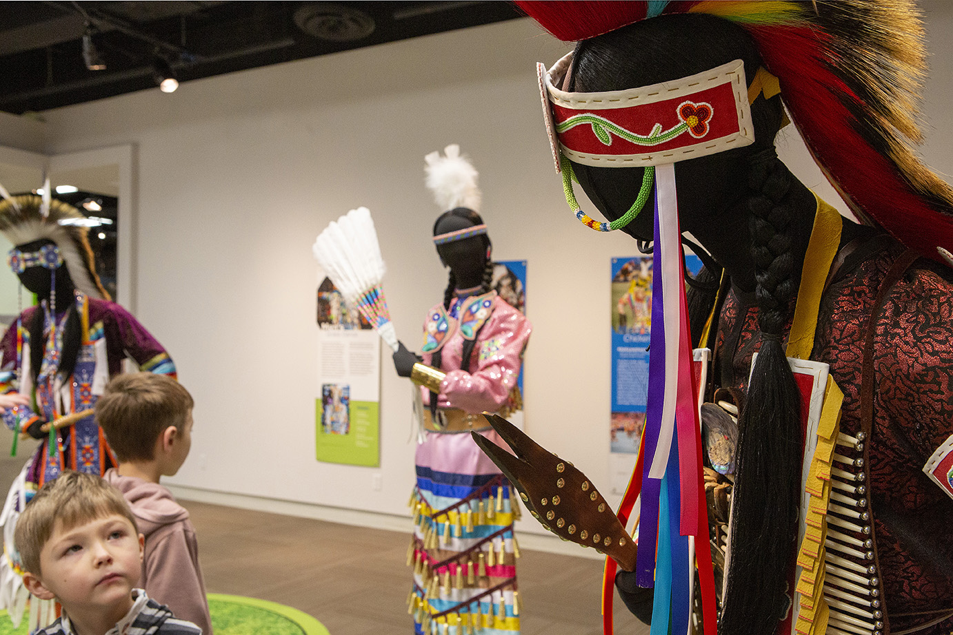 Red Deer Museum & Art Gallery with children admiring the aboriginal regailia displays