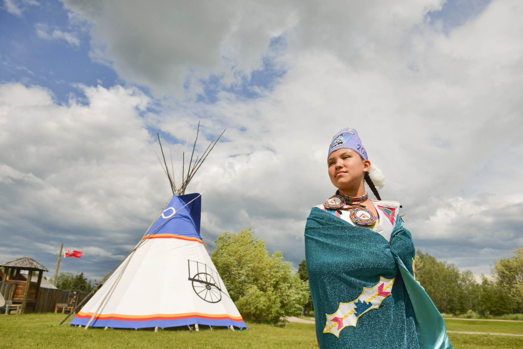 A tipi set up at Fort Normandeau with a woman in native regalia