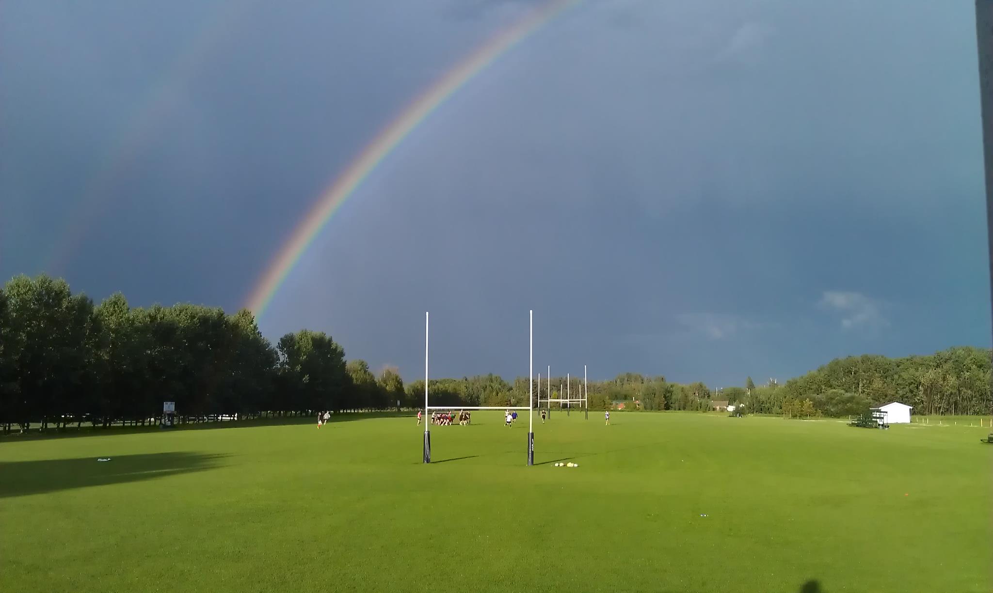 A rainbow over a sports field at Titans Rugby Park