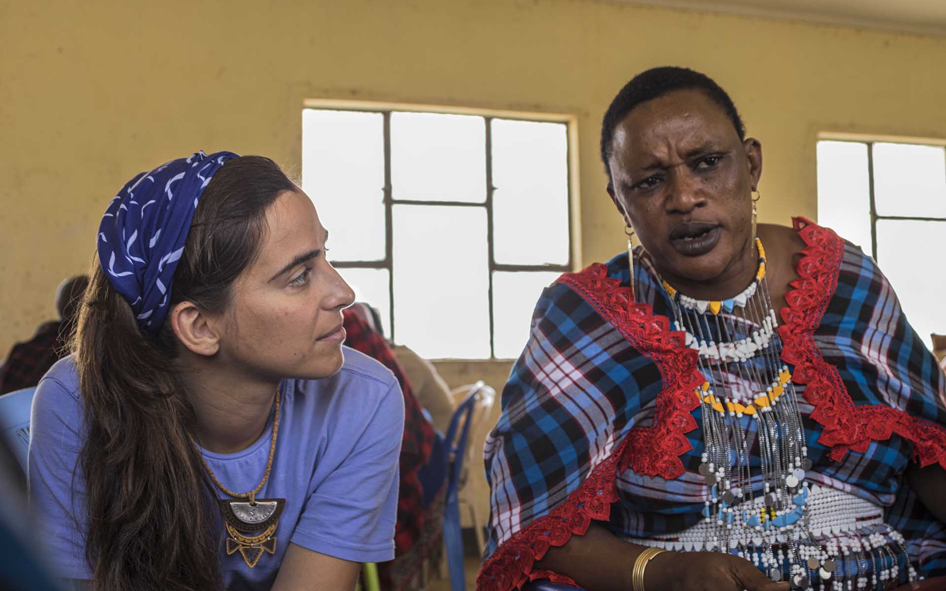 Two women have a conversation at a community event