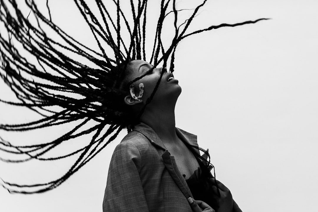 Dramatic Still of Woman with braids frozen in mid-air