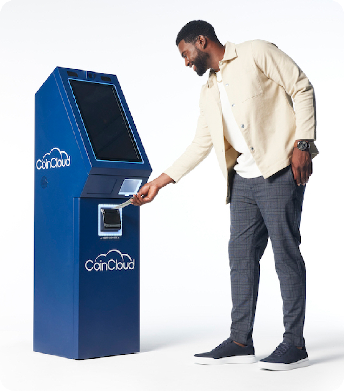 Man feeding money into a Coin Cloud digital currency machine kiosk