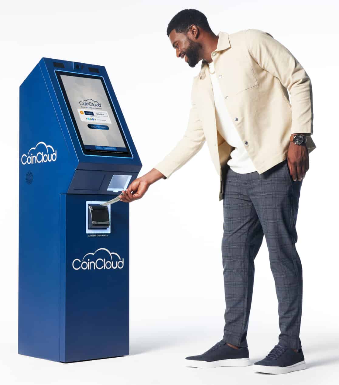 Man feeding money into a Coin Cloud digital currency machine kiosk