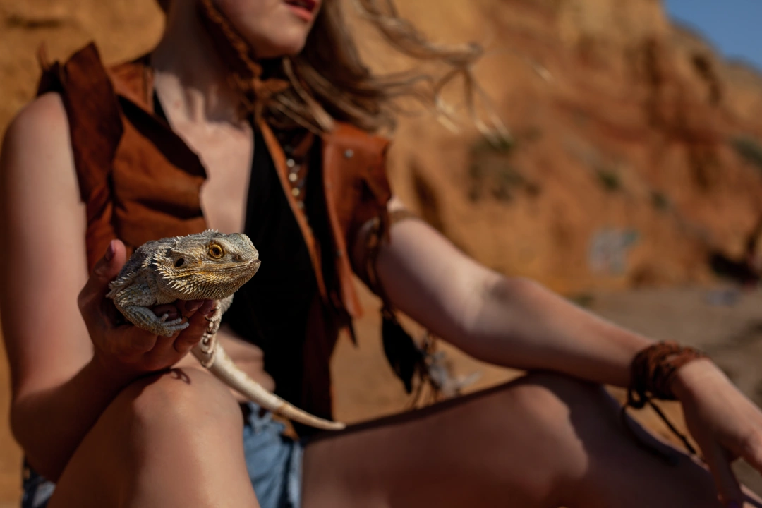 A woman outdoors with her emotional support lizard